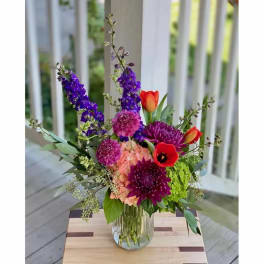 Colorful mixed bouquet in a clear glass vase on a table