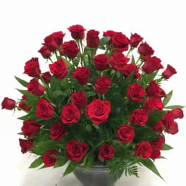 Large bouquet of red roses in a gray vase