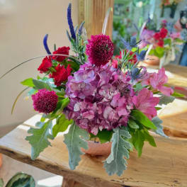 Bouquet of pink hydrangeas and red roses in a low vase