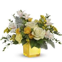 Yellow and white roses in a yellow glass vase with white alstroemeria