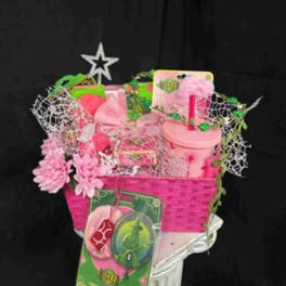 Pink gift basket with flowers, a tumbler, and assorted packaged items