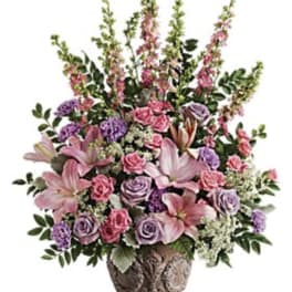 Pink and lavender floral arrangement in a decorative vase