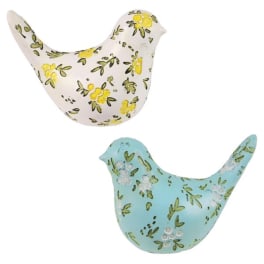 Two decorative bird figurines with floral patterns, one white and one blue