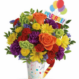 Colorful bouquet in a confetti vase with balloons and a "Celebrate!" sign