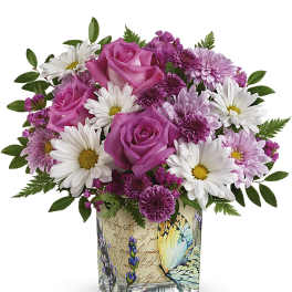Pink roses and white daisies in a decorative square vase