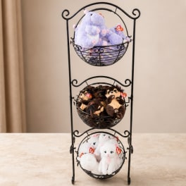 Three wire baskets filled with plush teddy bears on a metal stand
