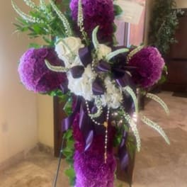 Purple and white floral arrangement with ribbon and hanging bead strands