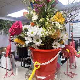 Mixed bouquet in a red bucket with a yellow shovel decoration