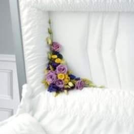 Purple and yellow floral arrangement on a white chair