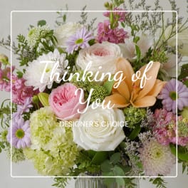 Mixed bouquet of roses, lilies, hydrangeas, and daisies in a glass vase