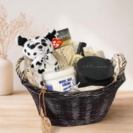 Gift basket with a plush dalmatian, skincare items, and a black woven basket