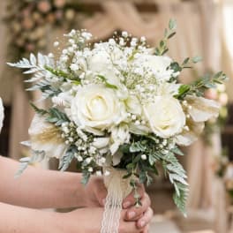 White rose bridal bouquet with baby's breath and lace wrap