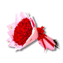 Bouquet of red roses wrapped in pink paper with a red ribbon