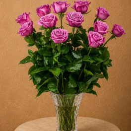 Pink roses arranged in a clear glass vase