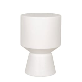 White ceramic pedestal vase on a plain background