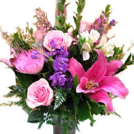Pink and purple mixed bouquet in a glass vase with a ribbon