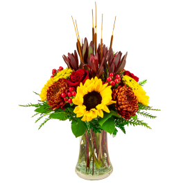 Sunflower and red chrysanthemum arrangement in a clear glass vase