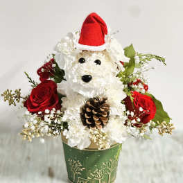 Dog-shaped floral arrangement with red roses in a green pot