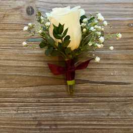 White rose boutonniere with baby's breath and burgundy ribbon