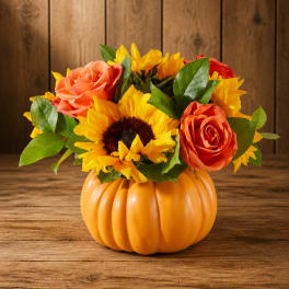 Sunflower and rose arrangement in an orange pumpkin container