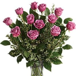 Pink roses arranged in a clear glass vase