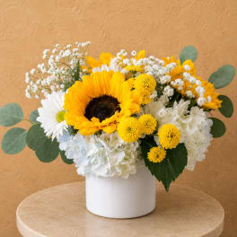 Sunflower and white daisy bouquet in a white vase