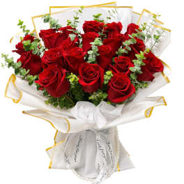 Bouquet of red roses wrapped in white paper with gold trim