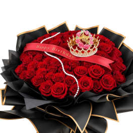 Large bouquet of red roses with a birthday ribbon and crown decoration
