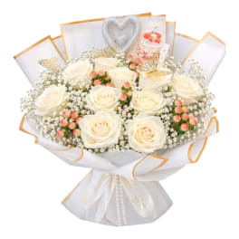 White rose bouquet with baby’s breath, pink berries, and silver heart topper
