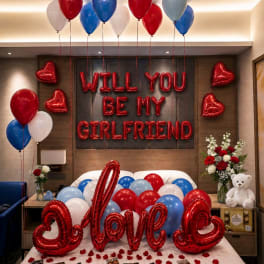Red heart balloons and a "Will You Be My Girlfriend" balloon display with a teddy bear