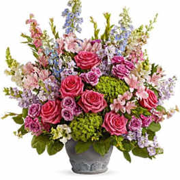 Pink and lavender mixed flower arrangement in a gray vase