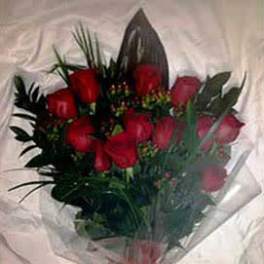 Bouquet of red roses wrapped in clear plastic with a red bow