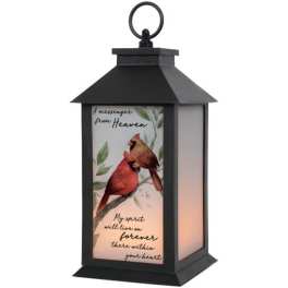 Black lantern with a cardinal memorial design and warm light inside