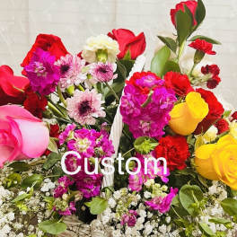 Mixed bouquet of roses, carnations, and daisies with white filler flowers