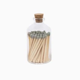 Glass bottle filled with wooden matches and sealed with a cork lid
