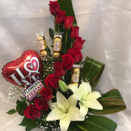 Red roses and white lilies with a heart balloon and chocolates