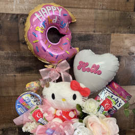 Hello Kitty birthday gift arrangement with balloons, candy, and flowers