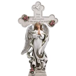 Angel memorial statue with a cross and roses