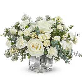 White roses and carnations in a clear square vase