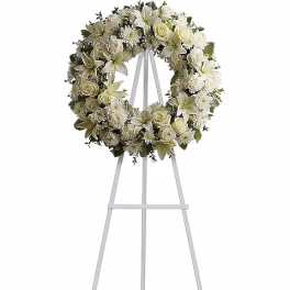 White floral wreath on a standing easel