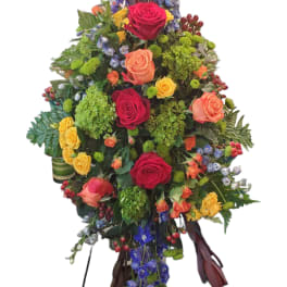 Tall floral arrangement with roses and purple hanging blooms