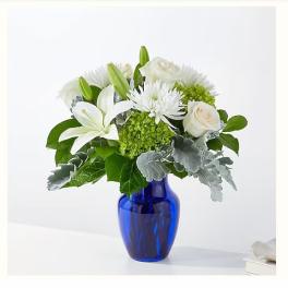 White flowers arranged in a blue glass vase