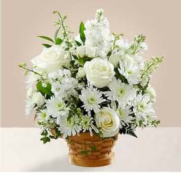 White roses and daisies arranged in a woven basket