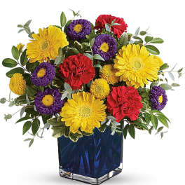 Colorful bouquet of yellow, purple, and red flowers in a blue vase