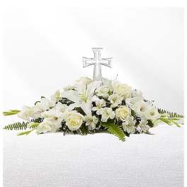 White floral casket spray with a clear cross centerpiece