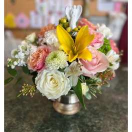 Mixed bouquet with a yellow lily and pink and white roses in a metal vase