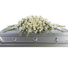 White floral casket spray on a silver casket