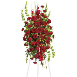 Tall red floral spray on a white easel