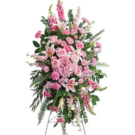Tall pink floral standing spray on an easel with lilies and roses