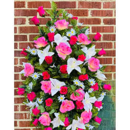 Pink and white floral standing spray on an easel